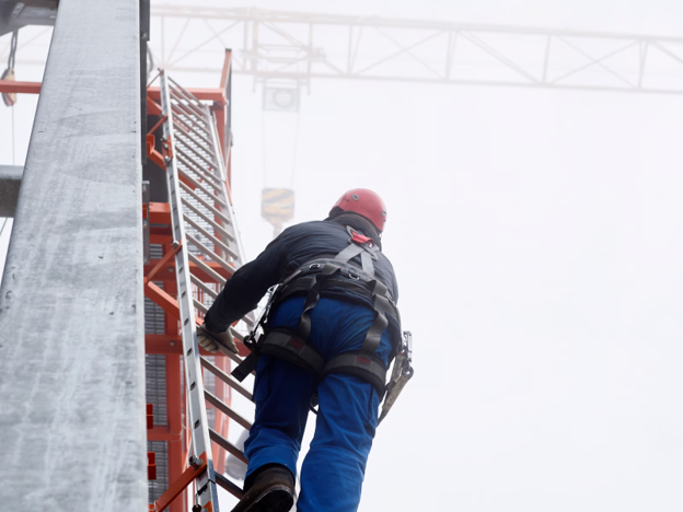 A man working at height after performing a risk assessment and preparing for any potential incidents that might occur.