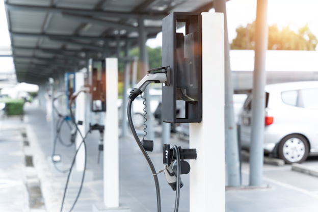 EV charging infrastructure installation in a commercial car park, featuring multiple electric vehicle charging stations for public and workplace use.